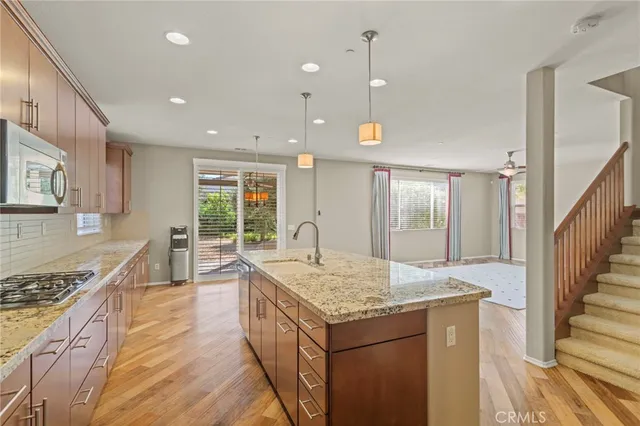 a kitchen with granite countertop sink stove and granite counter top