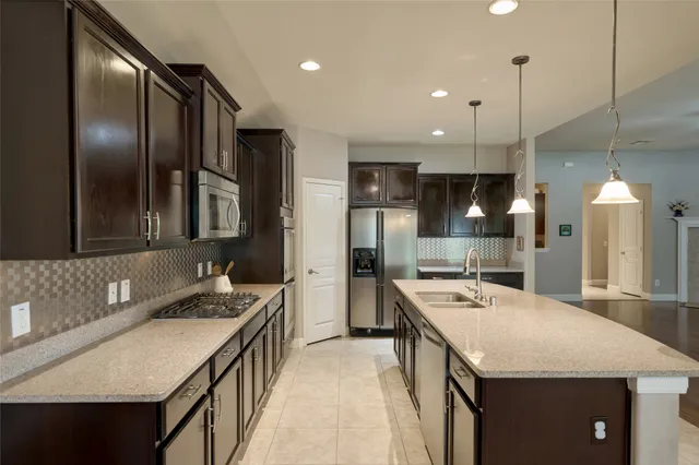 an empty room with wooden floor and a large window