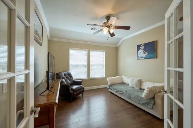 a spacious bedroom with a bed and a chandelier