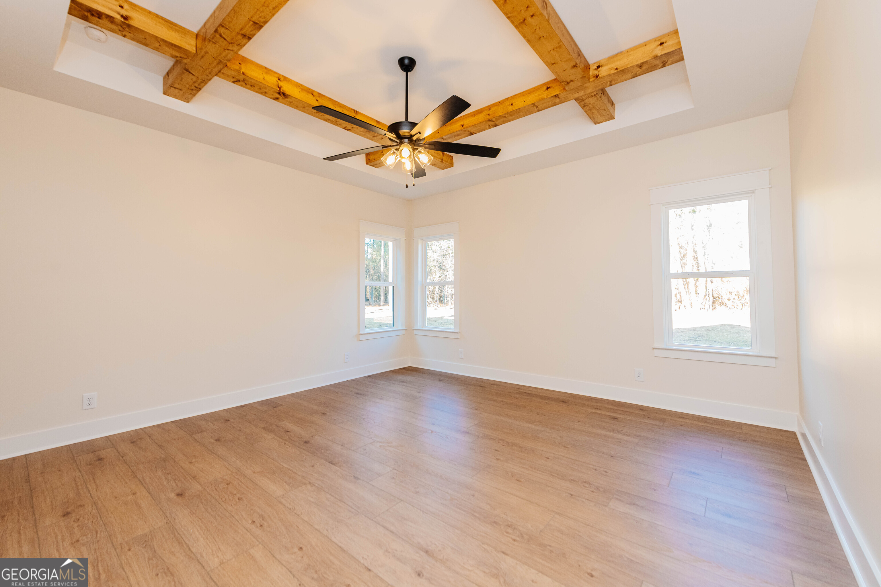 2089 Willow Lake Road Fort Valley, GA 31030 - Photo 13 of 50 an empty room with wooden floor fan and windows
