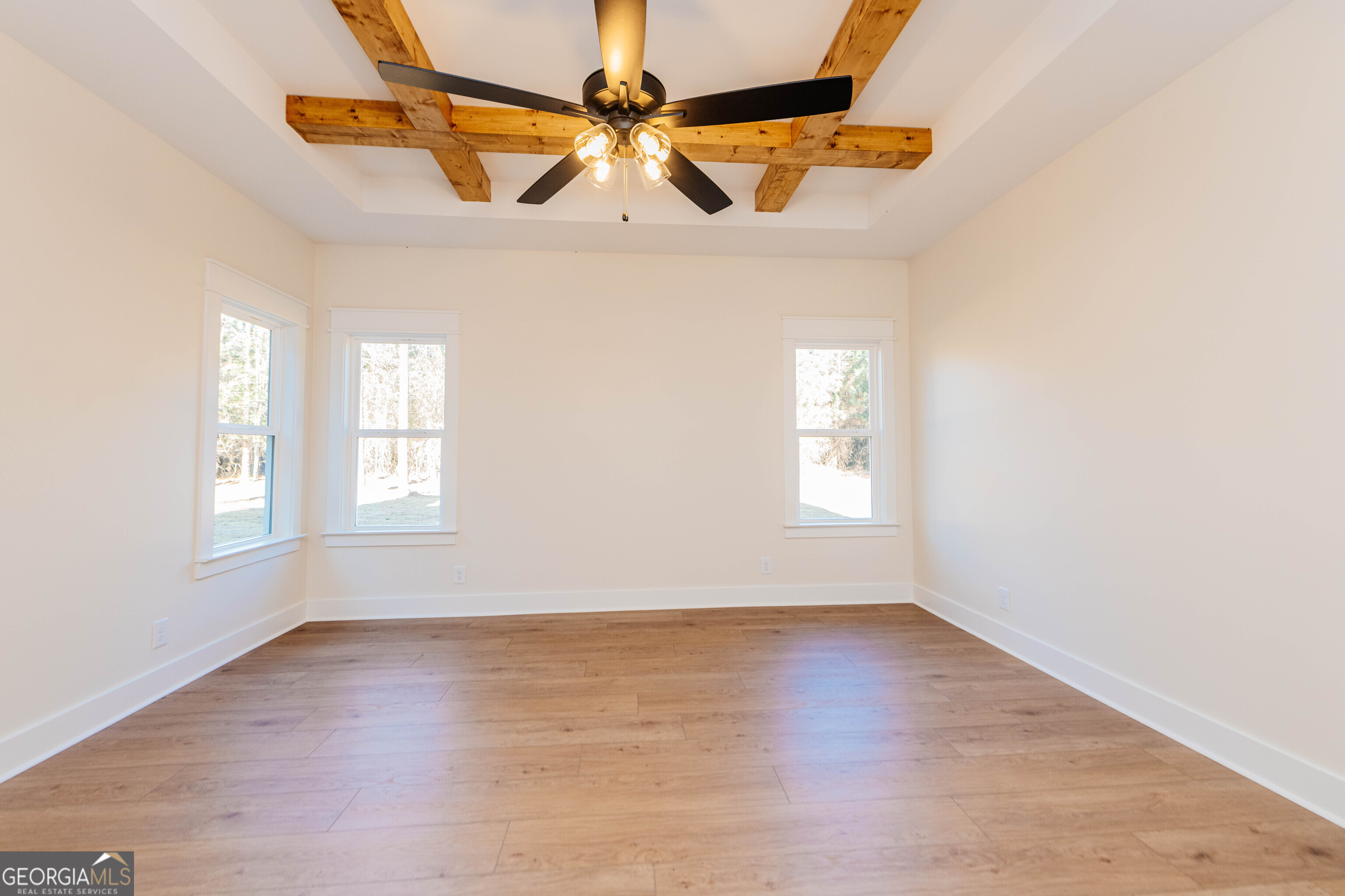 2089 Willow Lake Road Fort Valley, GA 31030 - Photo 14 of 50 an empty room with wooden floor windows and ceiling fan
