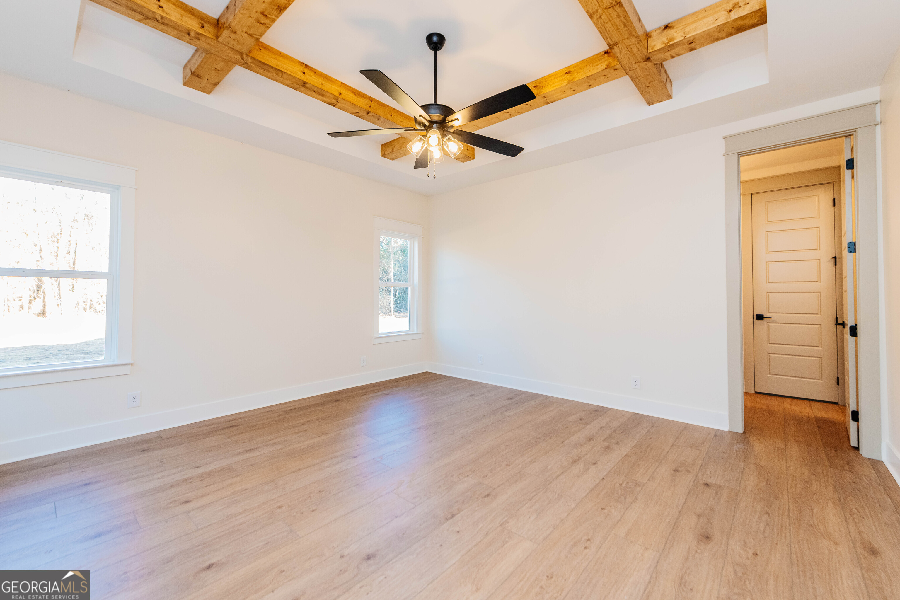 2089 Willow Lake Road Fort Valley, GA 31030 - Photo 15 of 50 an empty room with wooden floor fan and windows