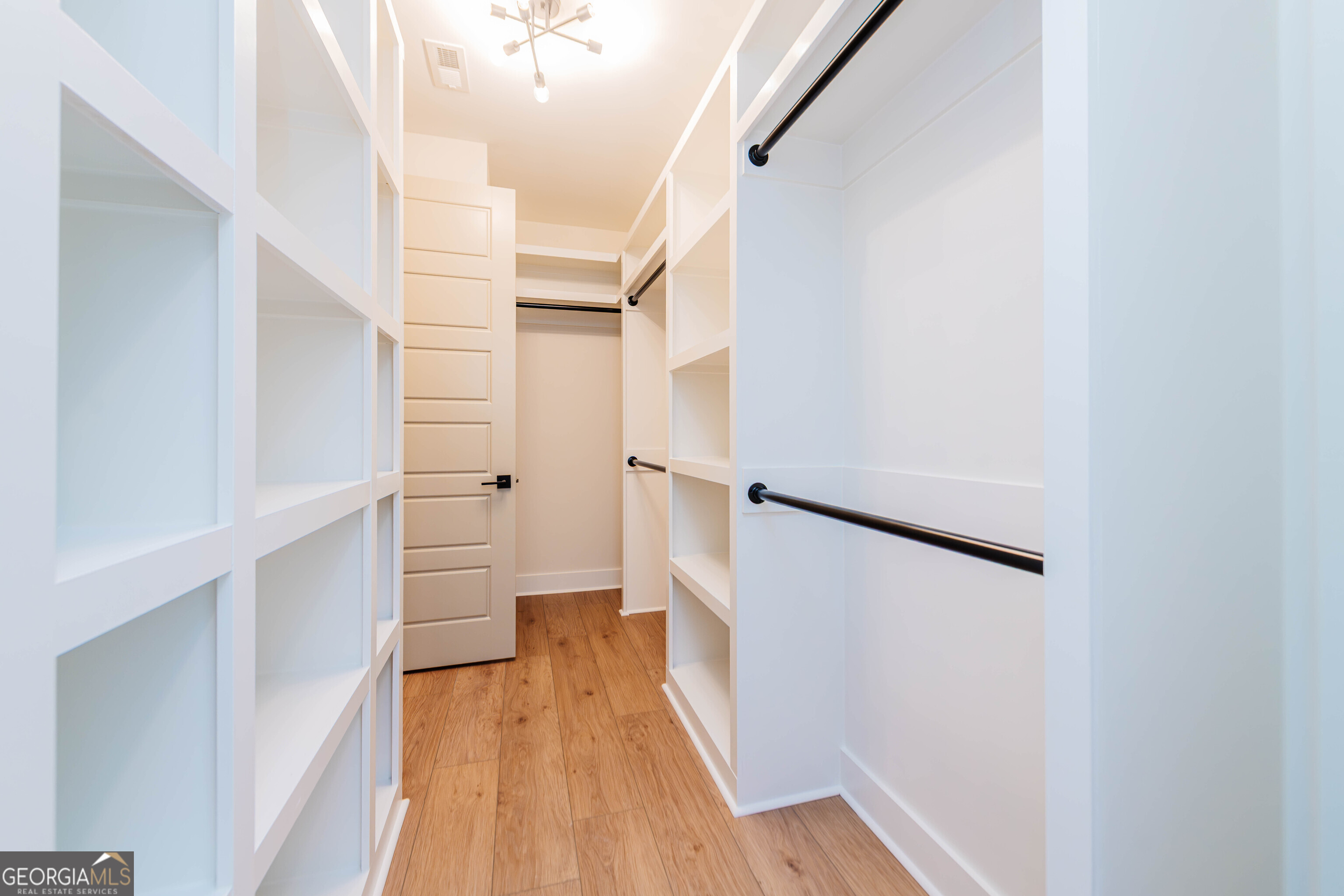 2089 Willow Lake Road Fort Valley, GA 31030 - Photo 23 of 50 a view of walk in closet with wooden floor and a white door