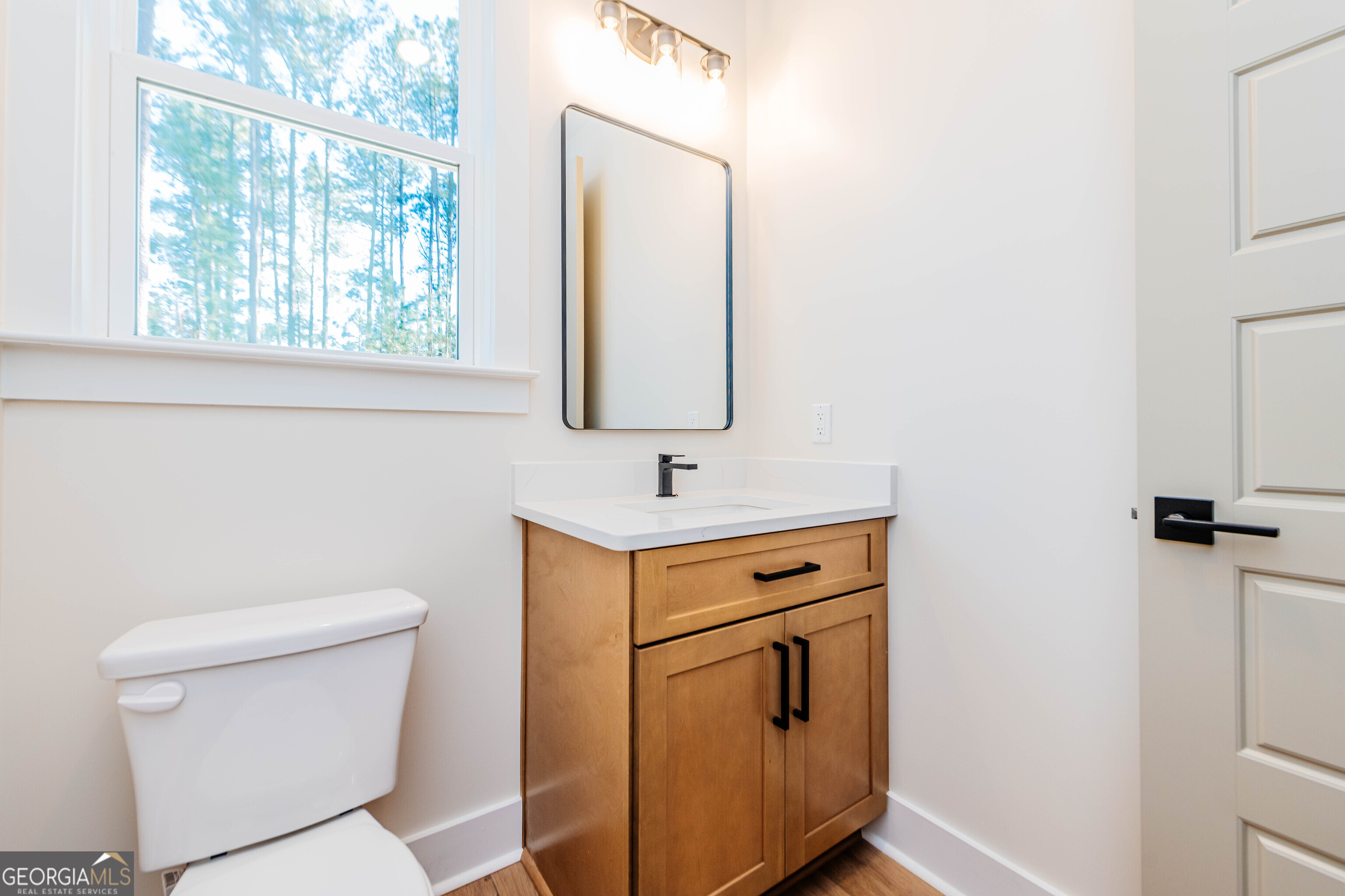 2089 Willow Lake Road Fort Valley, GA 31030 - Photo 29 of 50 a bathroom with a toilet sink and mirror