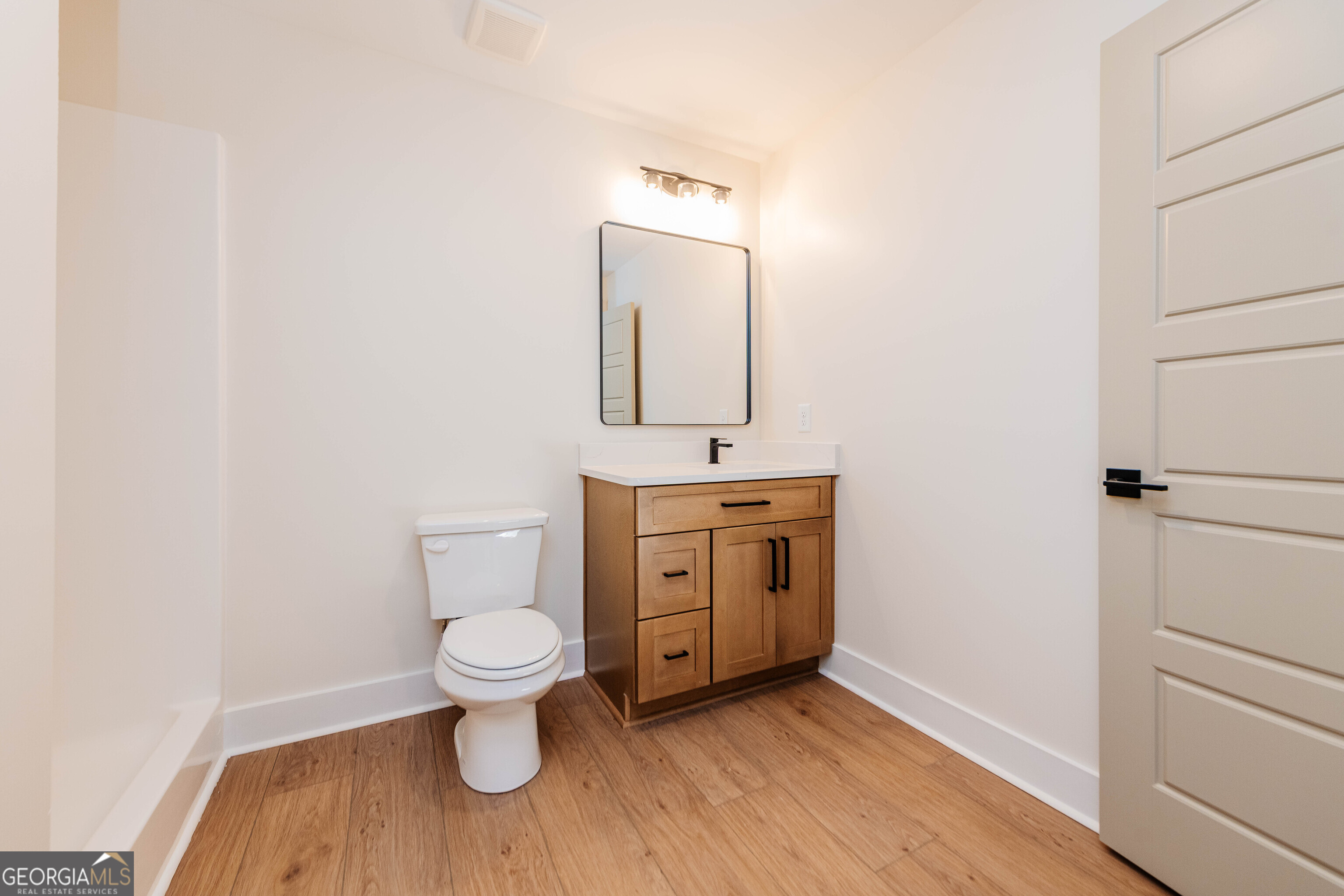 2089 Willow Lake Road Fort Valley, GA 31030 - Photo 34 of 50 a bathroom with a toilet sink and mirror