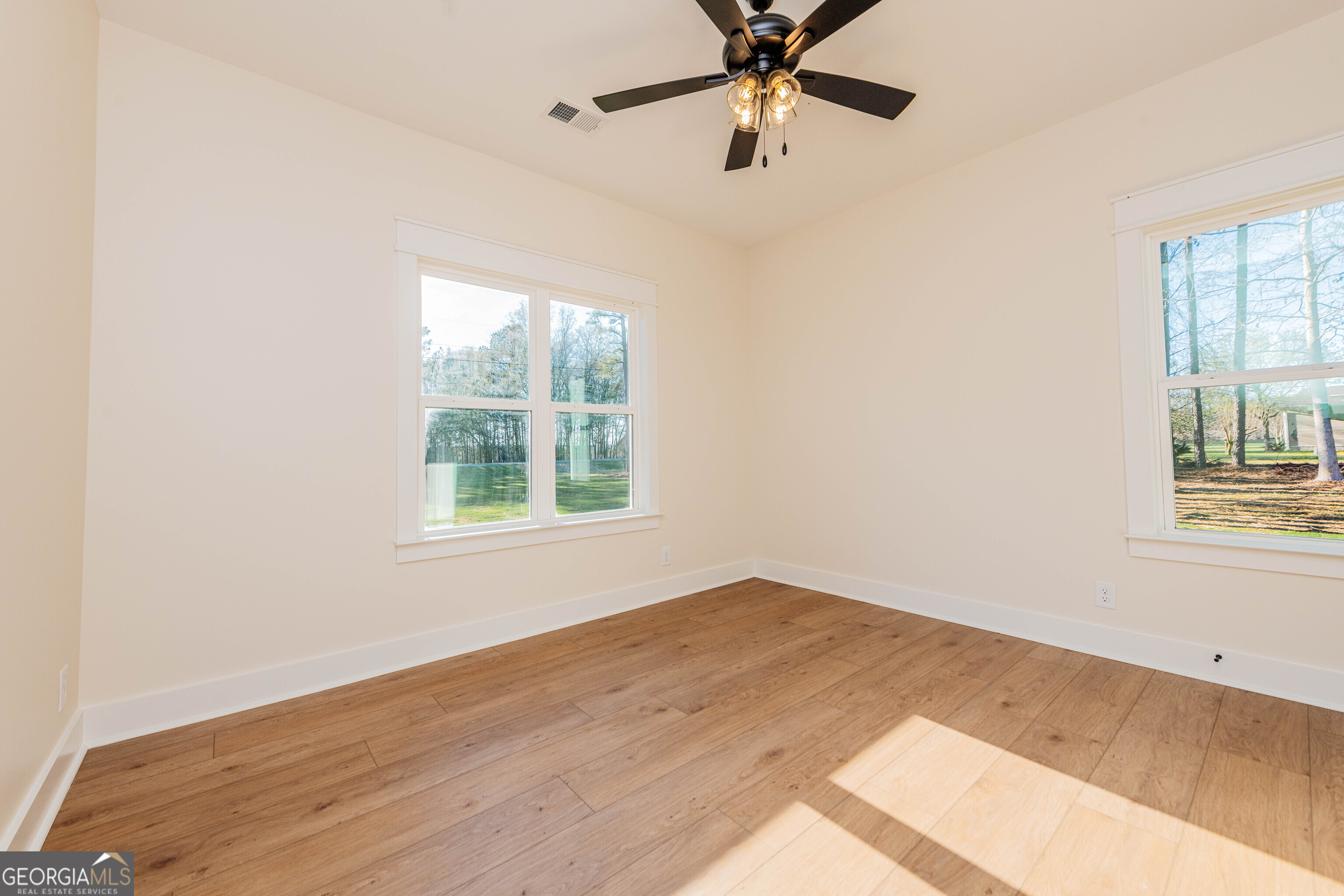 2089 Willow Lake Road Fort Valley, GA 31030 - Photo 38 of 50 an empty room with a window and a fan