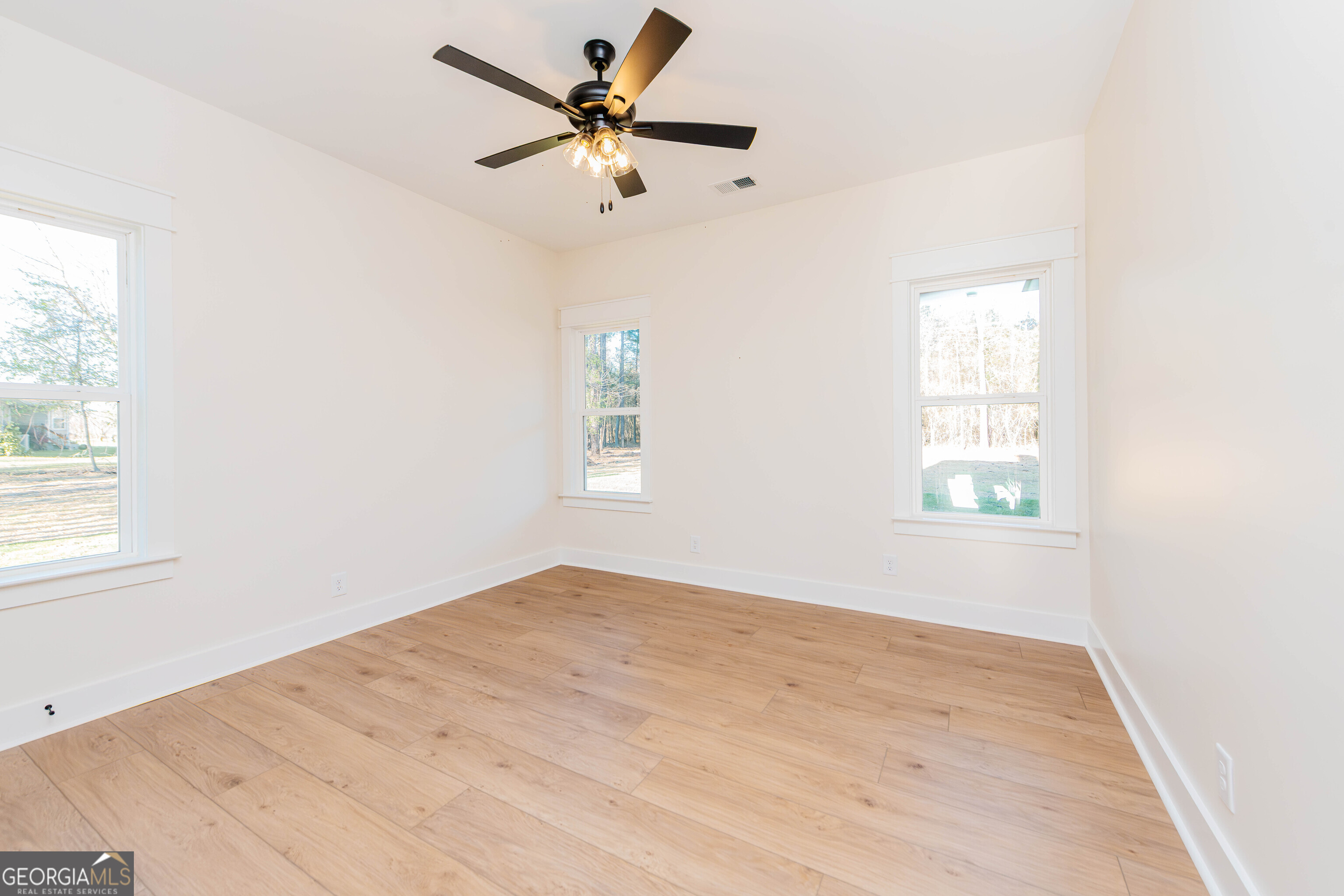2089 Willow Lake Road Fort Valley, GA 31030 - Photo 42 of 50 an empty room with a window and a fan