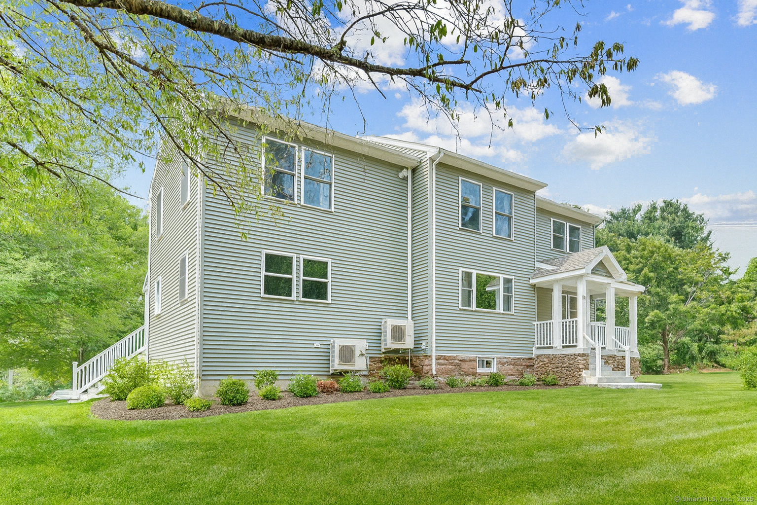a front view of a house with a garden