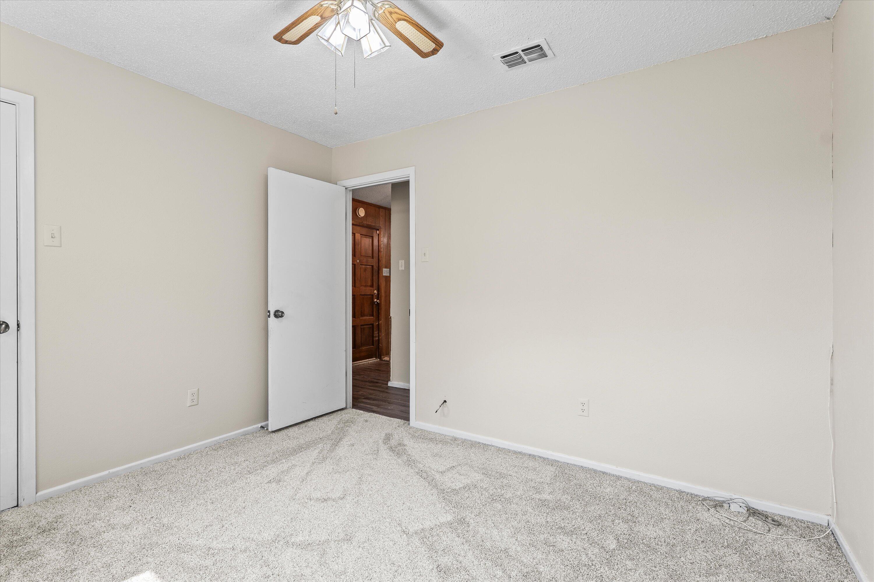 4520 54th Street Lubbock, TX 79414 - Photo 23 of 32 an empty room with a ceiling fan and a window