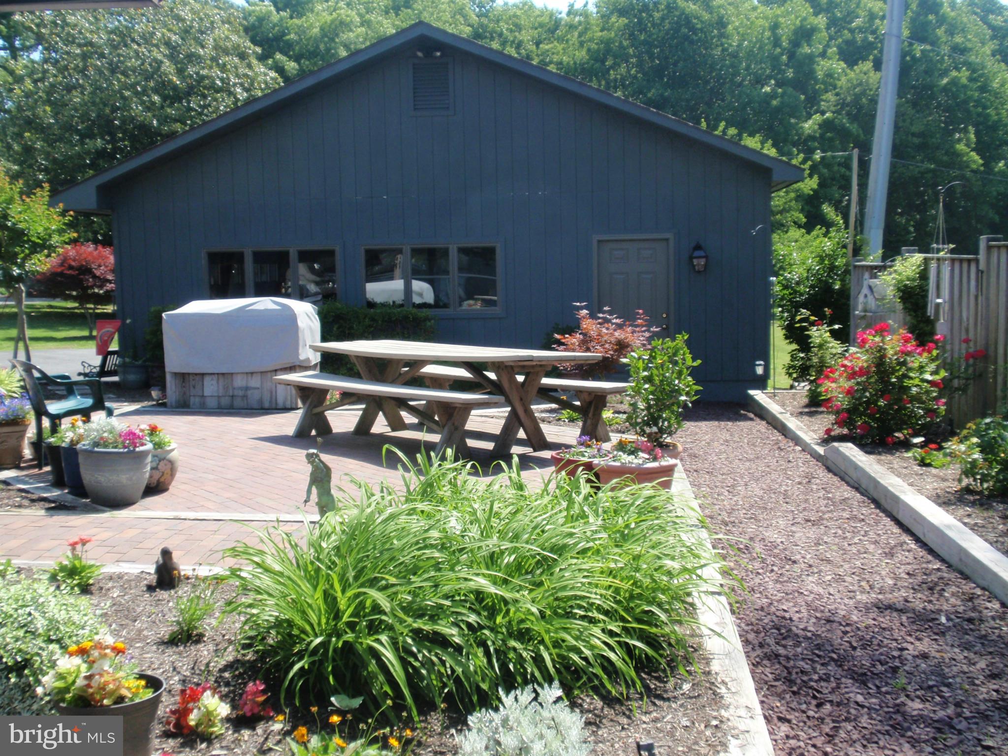 24468 Half Pone Point Road Hollywood, MD 20636 - Photo 6 of 28 Landscaped patio..notice garage...