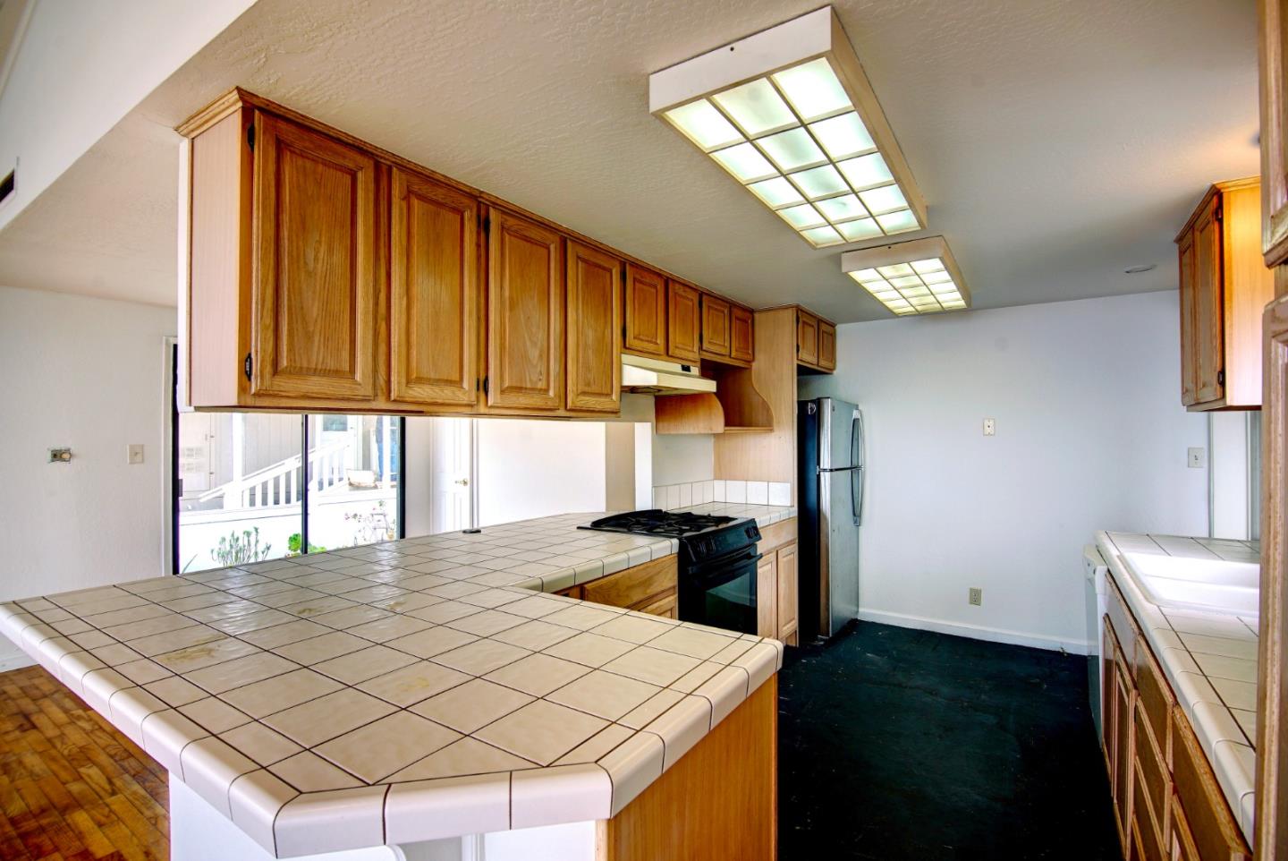 2395 Delaware Avenue, Unit 63 Santa Cruz, CA 95060 - Photo 11 of 16 a kitchen with a stove a sink and a microwave