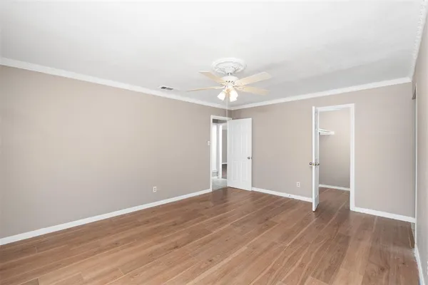 a view of an empty room with wooden floor