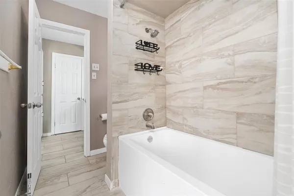 a bathroom with a bathtub and a shower