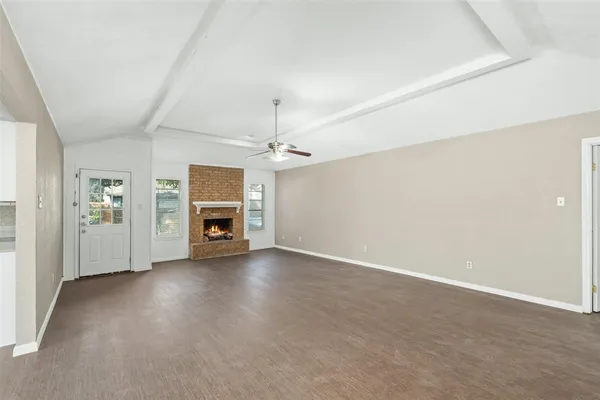 an empty room with a fireplace and cabinet