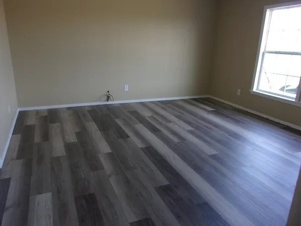 a view of wooden floor and windows in a room
