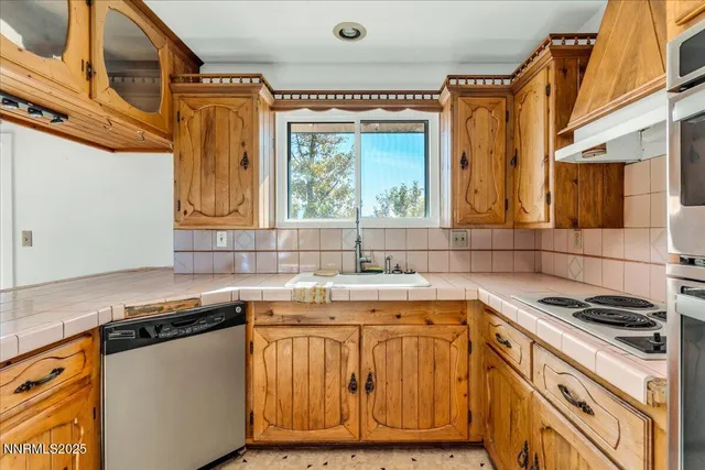 a kitchen with stainless steel appliances granite countertop a stove and a sink
