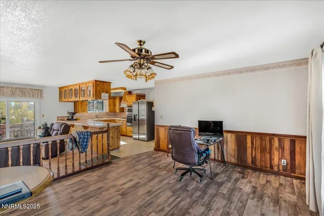 a view of a workspace with furniture and a window