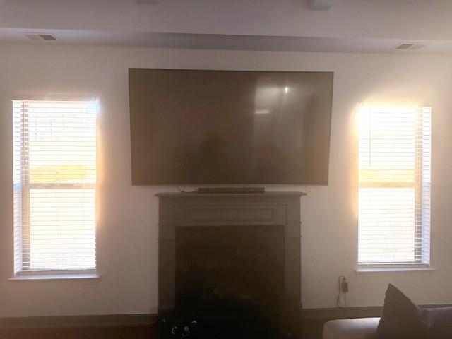12149 Centerra Drive Hampton, GA 30228 - Photo 15 of 48 a view of an empty room with a window and wooden floor