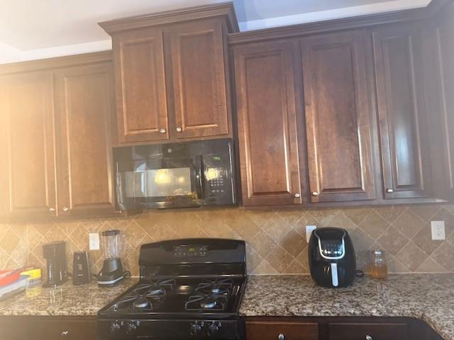 12149 Centerra Drive Hampton, GA 30228 - Photo 19 of 48 a kitchen with a stove and cabinets