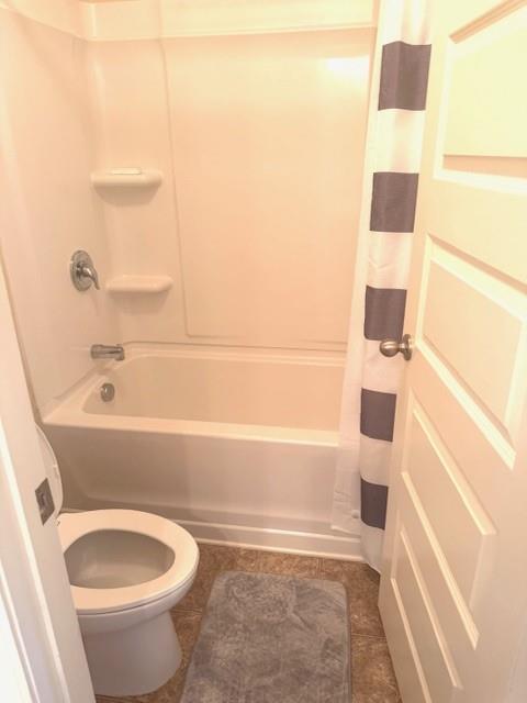 12149 Centerra Drive Hampton, GA 30228 - Photo 34 of 48 a bathroom with a bathtub and a shower