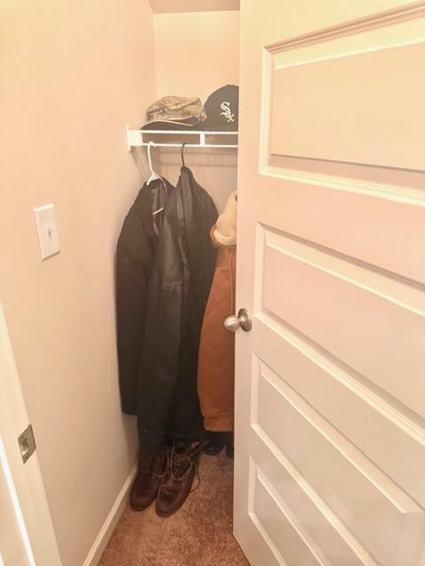 12149 Centerra Drive Hampton, GA 30228 - Photo 39 of 48 a view of walk in closet with clothes and shoes