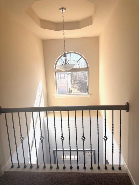 12149 Centerra Drive Hampton, GA 30228 - Photo 45 of 48 a view of staircase with railing and a chandelier