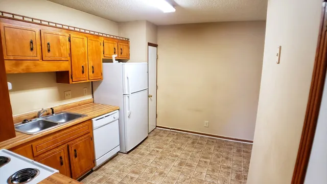 a kitchen with a refrigerator and cabinets