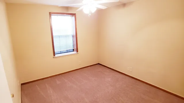 a view of an empty room and a window