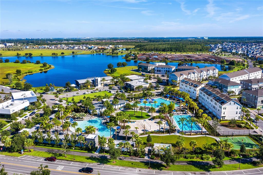 8555 Pinter Street Orlando, FL 32827 - Photo 24 of 32 an aerial view of a city with lots of residential buildings ocean and mountain view in back