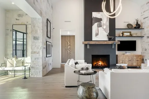 a living room with furniture a fireplace and a flat screen tv
