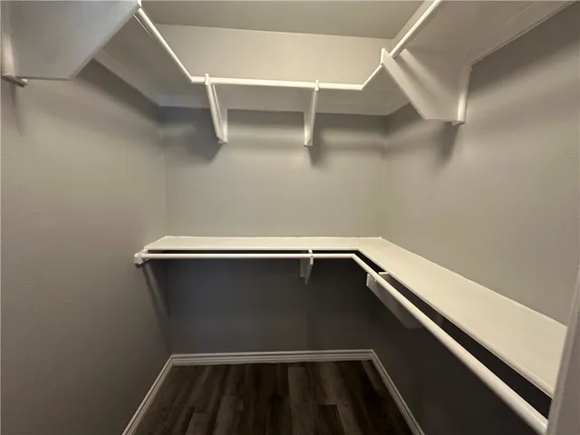 a bathroom with a granite countertop sink a mirror and shower