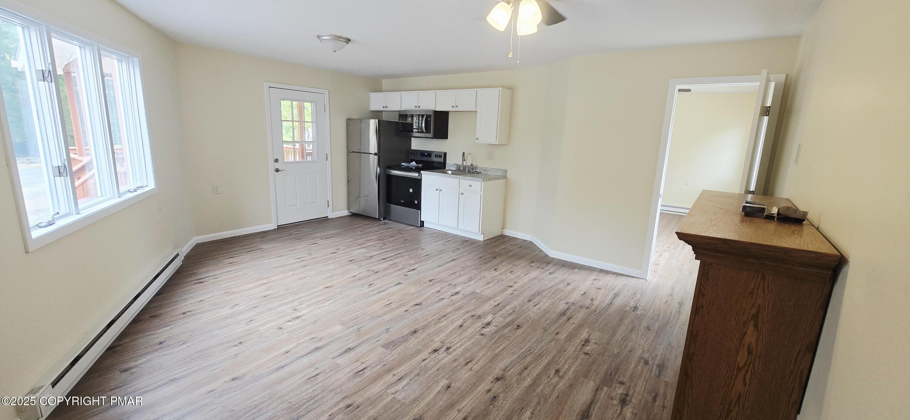 117 Rinker Road Stroudsburg, PA 18360 - Photo 31 of 33 a view of a kitchen from the hallway with a window and wooden floor