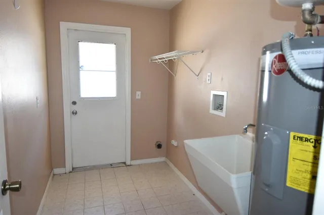 a kitchen with a wooden floor and a fireplace