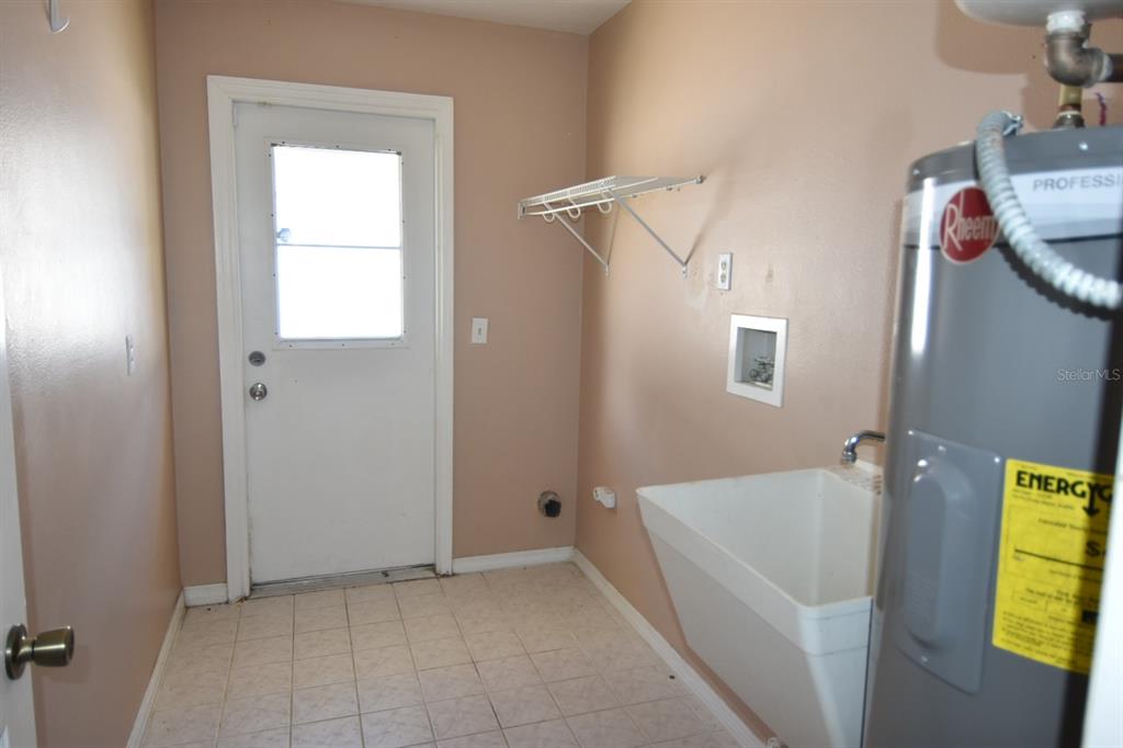 678 Fairchild Avenue Deltona, FL 32725 - Photo 14 of 45 a view of an empty room with a window and wooden floor