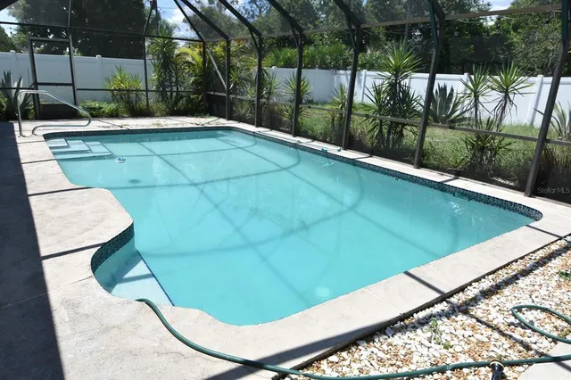 a view of a swimming pool with a patio