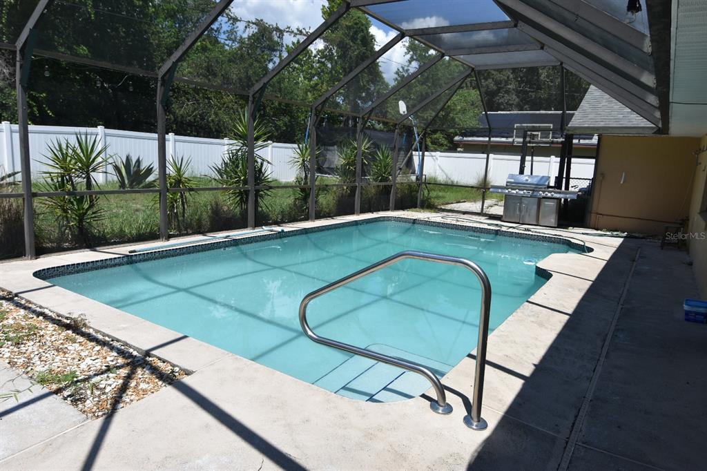 678 Fairchild Avenue Deltona, FL 32725 - Photo 18 of 45 a view of a swimming pool with a patio