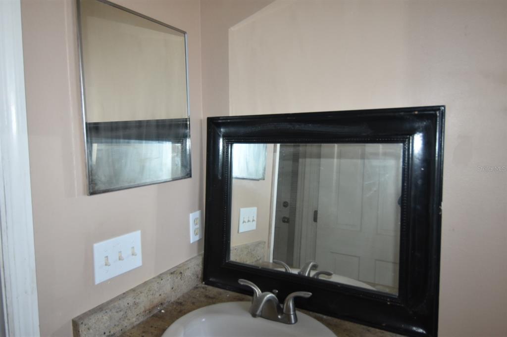 678 Fairchild Avenue Deltona, FL 32725 - Photo 25 of 45 a bathroom with a sink and a mirror