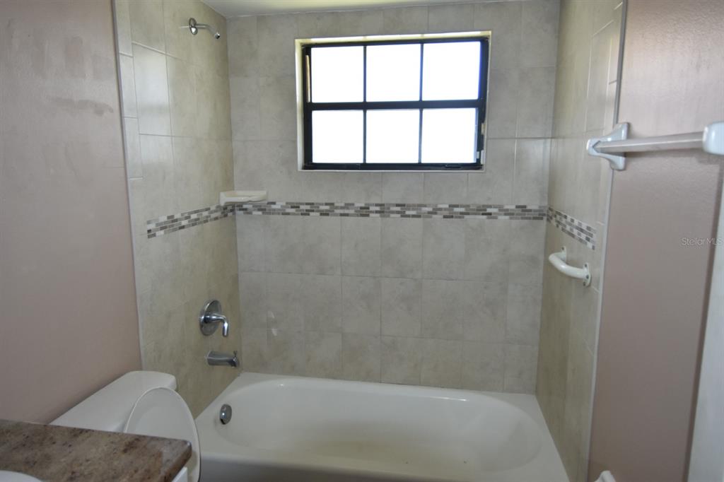 678 Fairchild Avenue Deltona, FL 32725 - Photo 26 of 45 a bath tub sitting next to a window