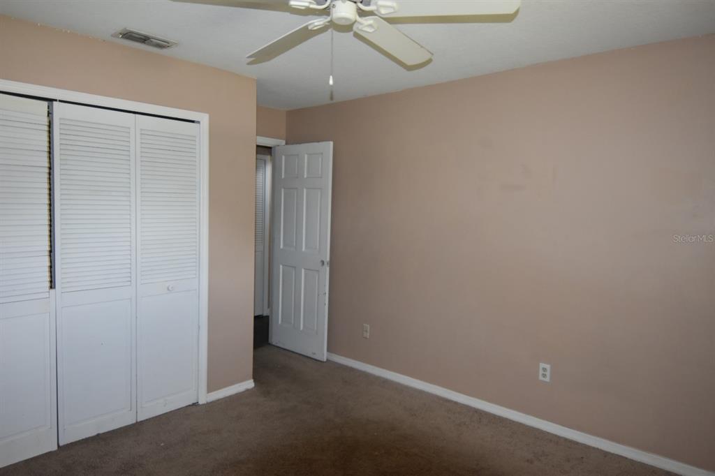 678 Fairchild Avenue Deltona, FL 32725 - Photo 27 of 45 an empty room with a ceiling fan and a window