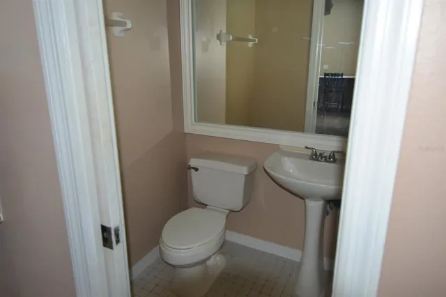 a bathroom with a toilet sink and shower