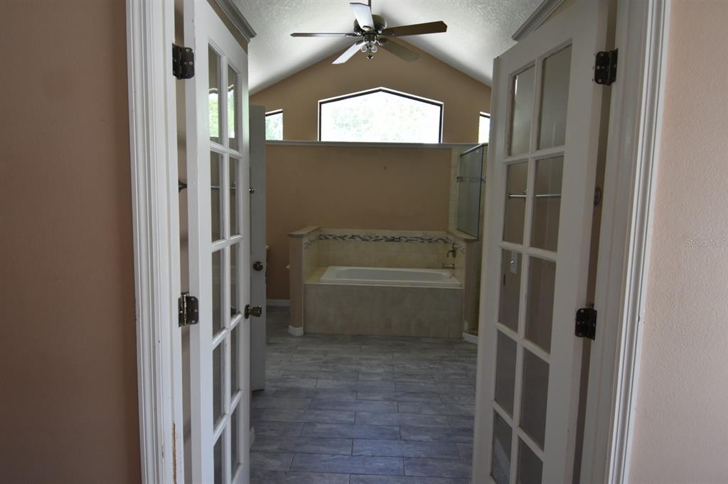 678 Fairchild Avenue Deltona, FL 32725 - Photo 32 of 45 a bathroom with a glass shower door and a window