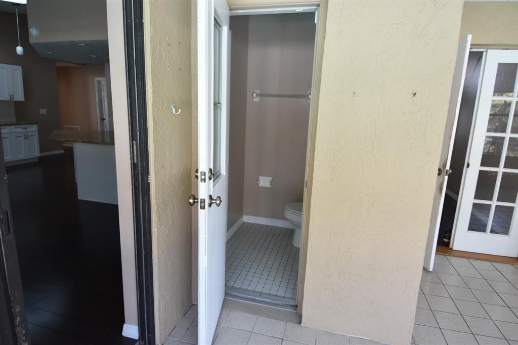 678 Fairchild Avenue Deltona, FL 32725 - Photo 34 of 45 a view of a hallway with wooden shelves
