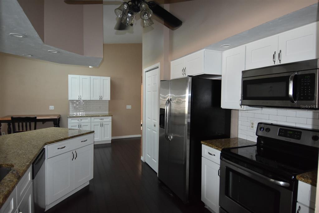 678 Fairchild Avenue Deltona, FL 32725 - Photo 41 of 45 a kitchen with a refrigerator stove and microwave