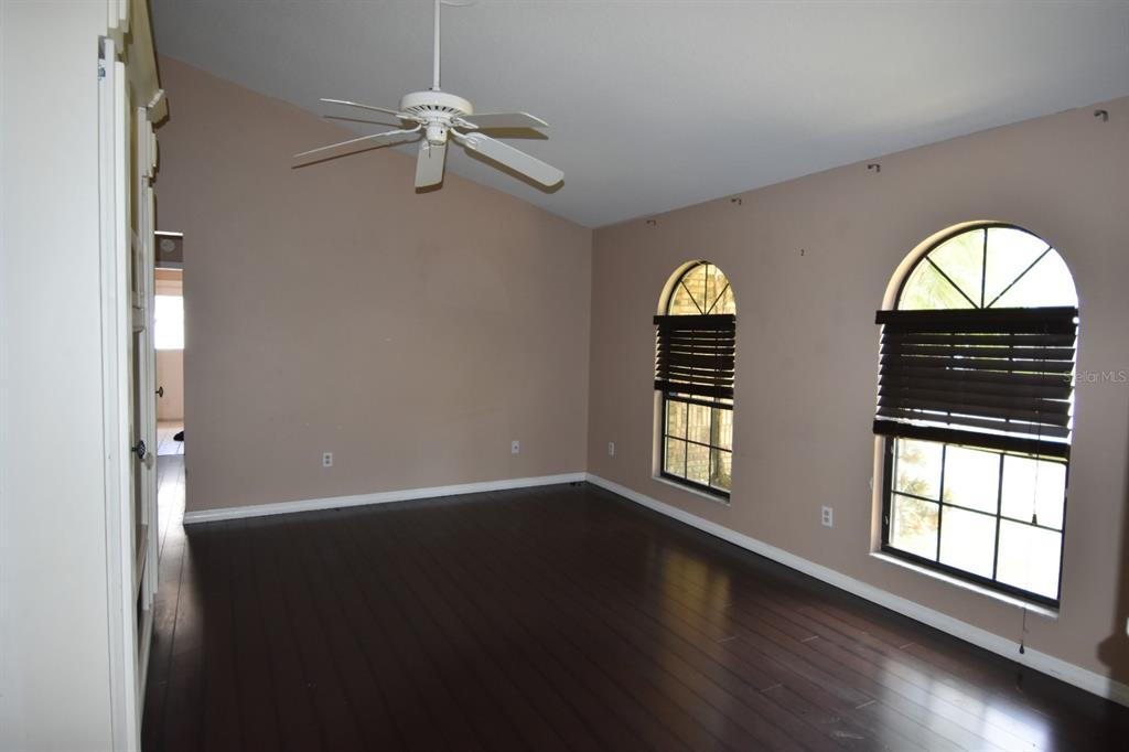 678 Fairchild Avenue Deltona, FL 32725 - Photo 43 of 45 wooden floor in an empty room with a window