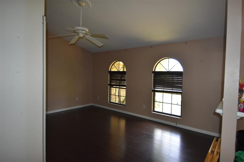 678 Fairchild Avenue Deltona, FL 32725 - Photo 44 of 45 an empty room with wooden floor windows and glass door