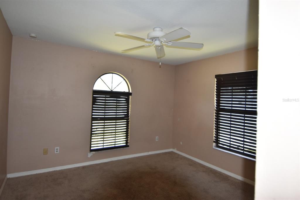 678 Fairchild Avenue Deltona, FL 32725 - Photo 45 of 45 an empty room with windows and fan