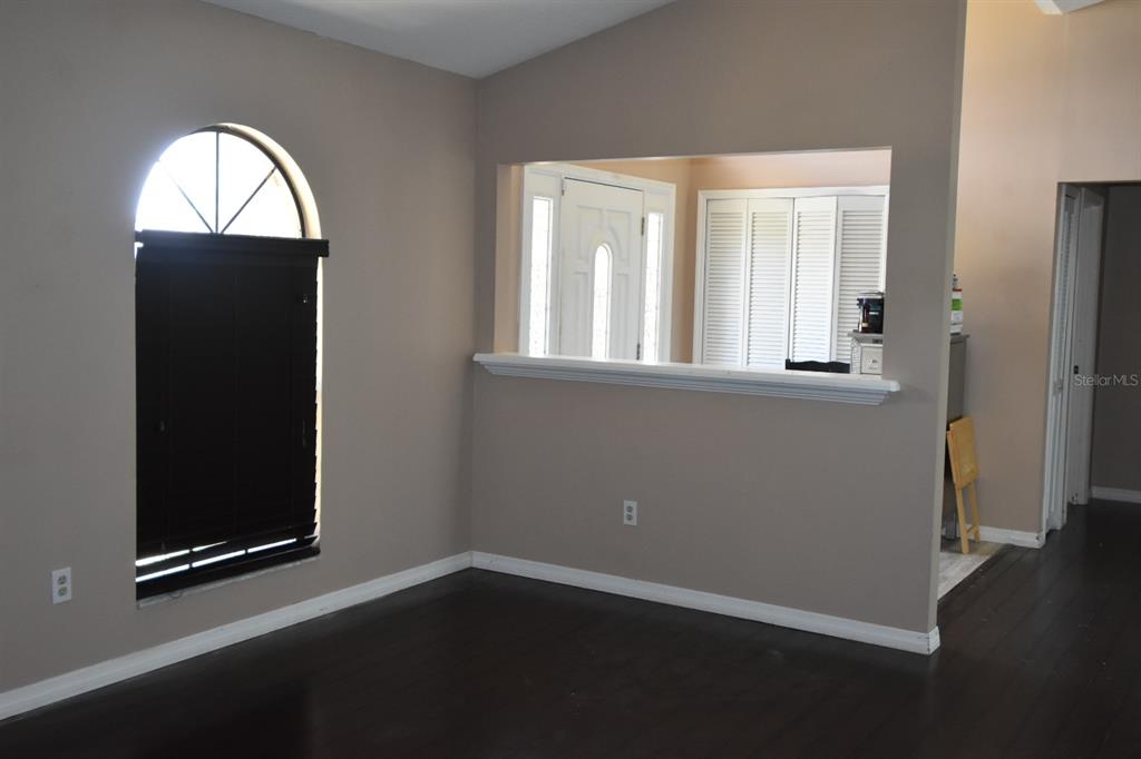678 Fairchild Avenue Deltona, FL 32725 - Photo 5 of 45 an empty room with wooden floor closet and windows