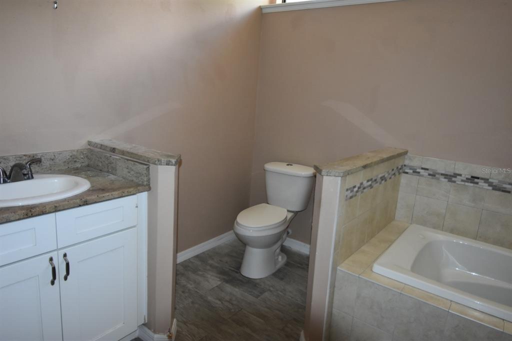 678 Fairchild Avenue Deltona, FL 32725 - Photo 8 of 45 a bathroom with a toilet sink and mirror