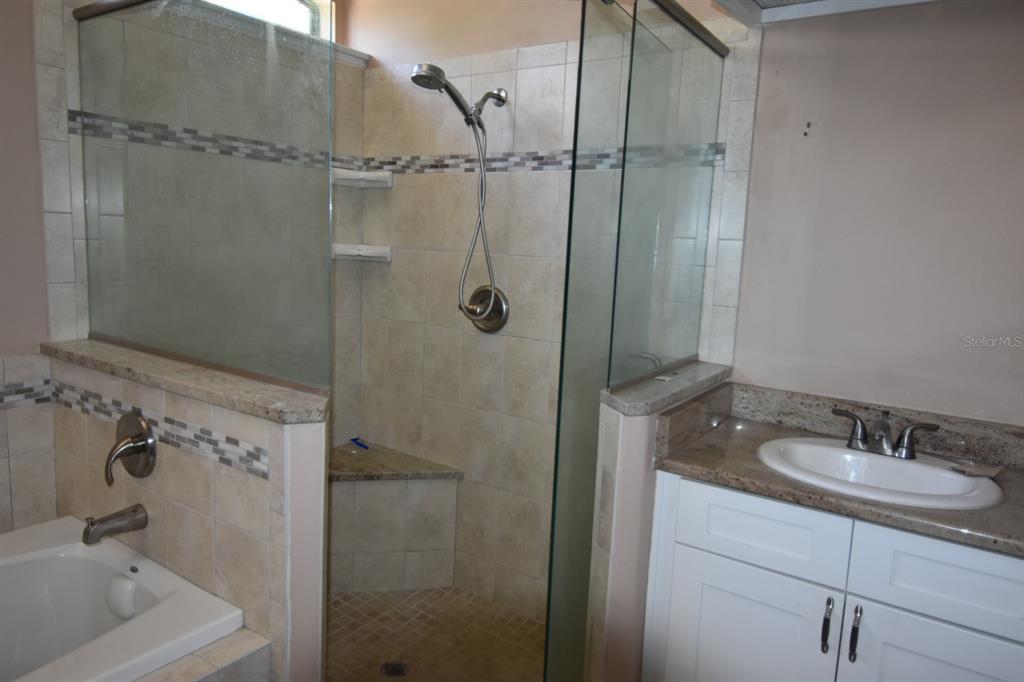 678 Fairchild Avenue Deltona, FL 32725 - Photo 10 of 45 a bathroom with a sink and shower
