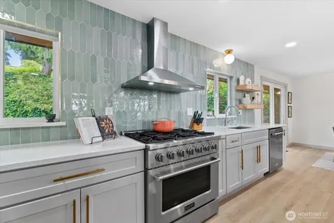 a kitchen with stainless steel appliances white cabinets and a stove